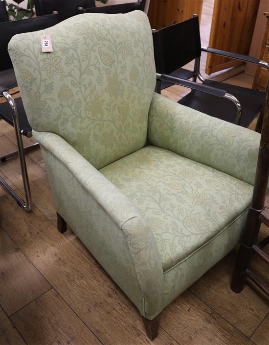 A green upholstered armchair